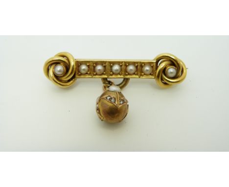 A Victorian brooch in the form of two knots each set with a pearl and a row of pearls between them, the egg ahped pendant dro