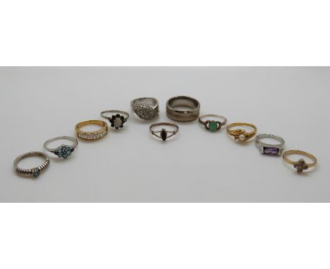 Eight silver rings, one set with an opal surrounded by sapphires and one set with an emerald and diamonds etc 