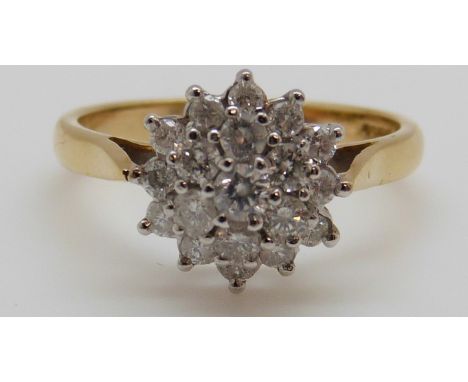 An 18ct gold ring set with diamonds in a cluster, total diamond weight approximately 0.75ct, 5g (size P) 