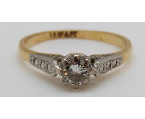 An 18ct gold ring set with a round cut diamond of approximately 0.3ct in a platinum setting (size K)