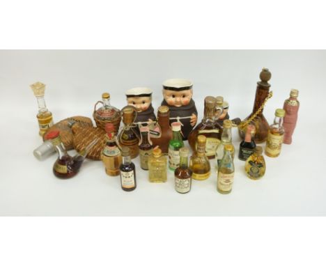Two novelty long necked bottles of Bessi, the larger 1973 the smaller 1969, with a collection of graduated Goebel monk jugs, 