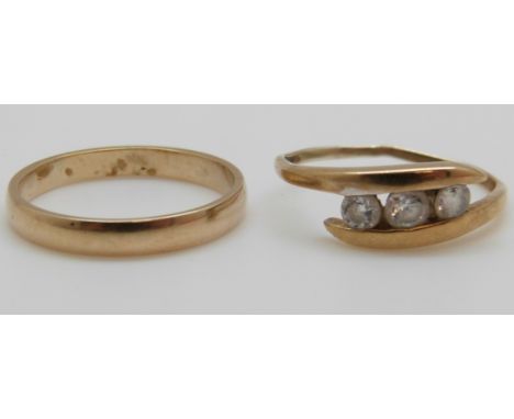 A 9ct gold wedding band and a 9ct gold ring set with cubic zirconia, 3.1g