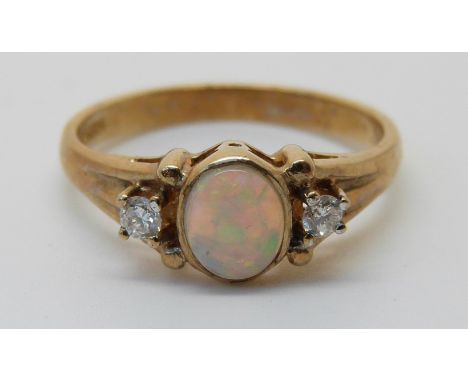 A 9ct gold ring set with an opal and diamonds (size N) 