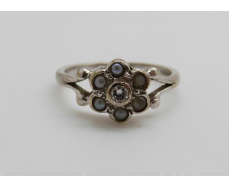 A 9ct white gold ring set with a diamond and seed pearls, 2.6g, size J/K 