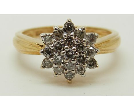 An 18ct gold ring set with diamonds in a cluster, total diamond weight approximately 0.5ct, 3.91g (size M) 