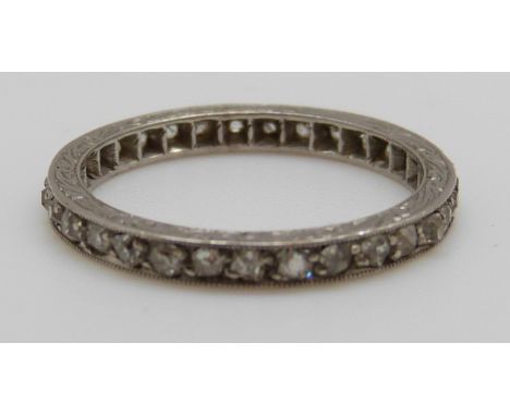 A platinum eternity ring set with diamonds (size J)