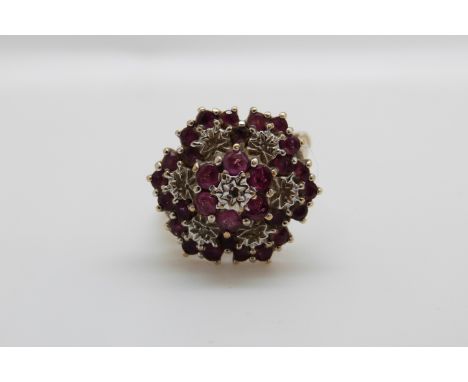 A 9ct gold ring set with diamonds and rubies in a large cluster, 3.8g, size J/K 