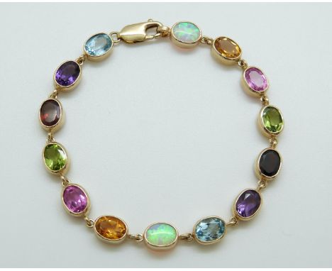 A 9ct gold bracelet set with oval opals, citrines, pink topaz, garnets, amethyst and blue topaz 