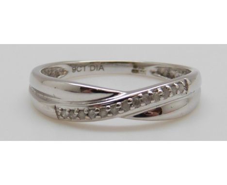 A 9ct white gold ring set with a row of diamonds in a cross over design in original Warren James box, 1.1g (size K)