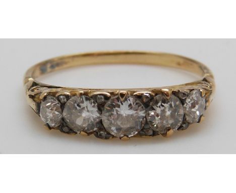 An 18ct gold ring set with five graduated diamonds, the centre diamond approximately 0.4ct (size R)