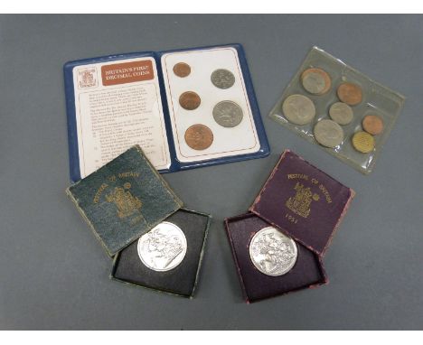 An uncirculated 1953 coronation set of UK coins together with two Festival of Britain crowns (green box and burgundy box) and