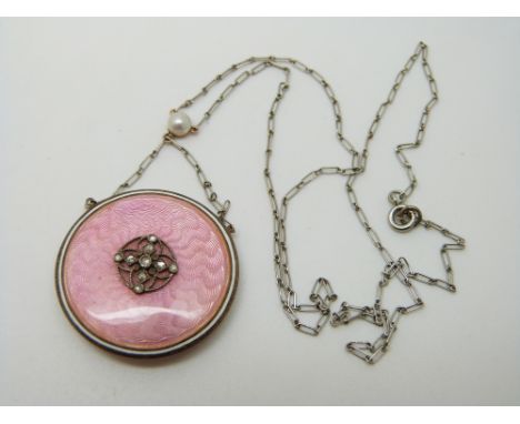 A Victorian pendant set with pink guilloche enamel, rose cut diamonds to the centre and a pearl to the platinum chain, verso 