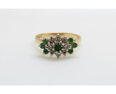 An 18ct gold ring set with emeralds and diamonds in a cluster (size K/L)