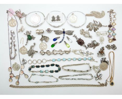 A collection of silver jewellery including a bracelet set with garnets, brooch set with garnets, brooch in the form of a frog