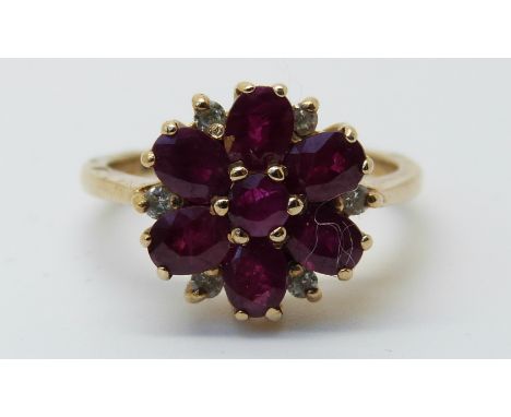 A white gold ring set with rubies and diamonds in a flower cluster (size K) 