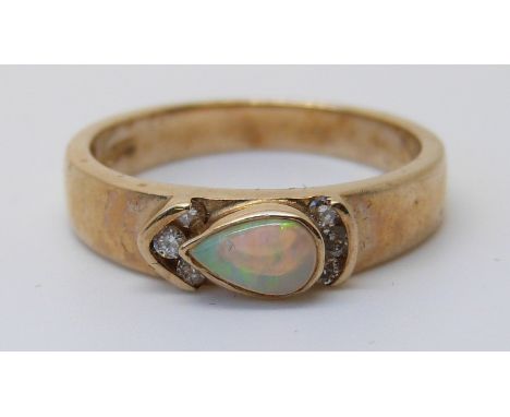 A 9ct gold ring set with a pear cut opal and diamonds (size M)