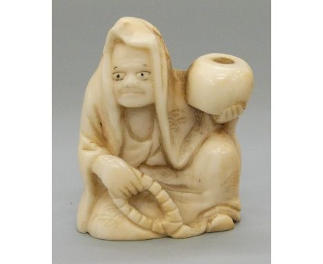 A Japanese Meiji period carved ivory netsuke of a man holding a bowl/gourd, 3.6cm 