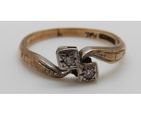 A 9ct gold ring set with two diamonds in a platinum setting, 2.1g (size N)