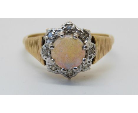 An 18ct gold ring set with an opal, surrounded by diamonds (size Q) 