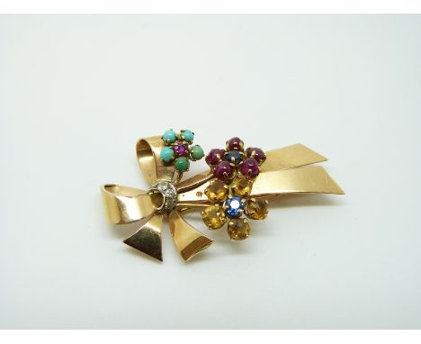 A French 18ct gold brooch set with ruby cabochons, sapphires, turquoise, diamonds and citrines in a floral and bow design, 4.