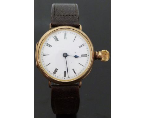 9ct gold gentleman's wristwatch converted from a pocket watch with Roman numerals, blued hands and white enamel dial, on blac