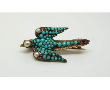 A Victorian gilt brooch in the form of a swallow set with turquoise cabochons, pearls and ruby cabochons, 3.6 x 1.9cm