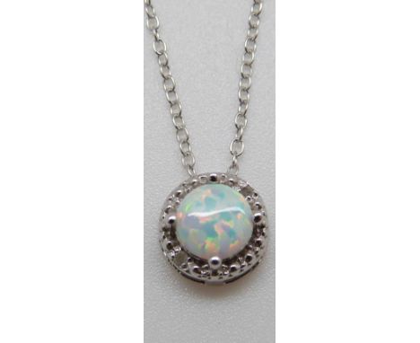 A silver necklace set with an opal cabochon and diamonds 