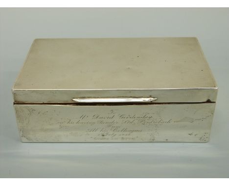 A hallmarked silver cigarette box with engine turned lid, marks rubbed, length 15.5cm