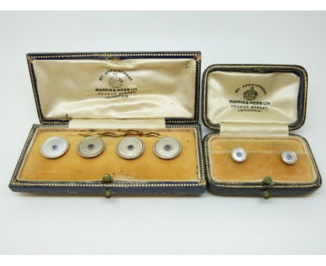 A set of four 9ct gold and platinum buttons set with mother of pearl and sapphires to the centre in original Mappin & Webb bo