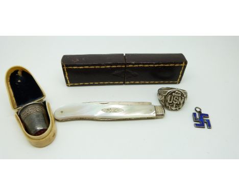 A Victorian silver and mother of pearl fruit knife in original case, white metal thimble in bakelite case, US Navy sterling s