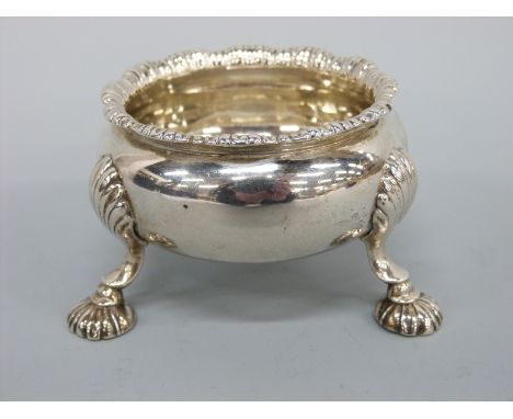 A William IV or Victorian (first year of reign) large hallmarked silver salt raised on three hoof feet with shell decoration 