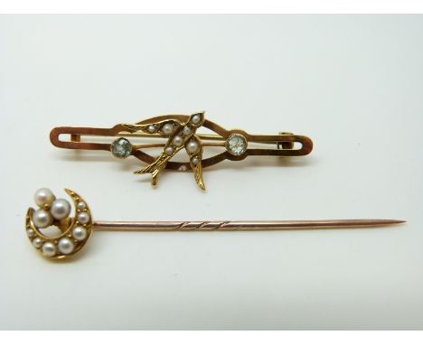 A 9ct gold brooch set with seed pearls and aquamarines in the form of a swallow and a Victorian stick pin set with seed pearl