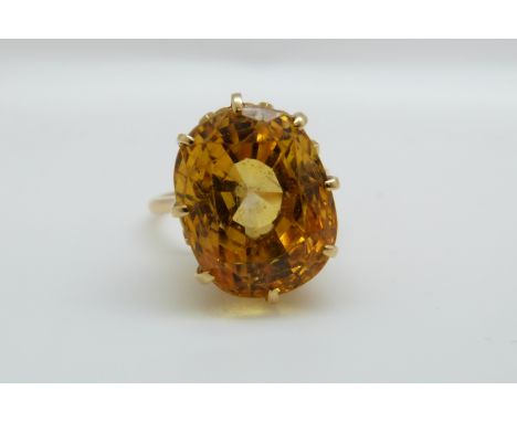 An 18ct gold ring set with a mixed cut natural untreated yellow sapphire measuring approximately 20ct, origin believed to be 