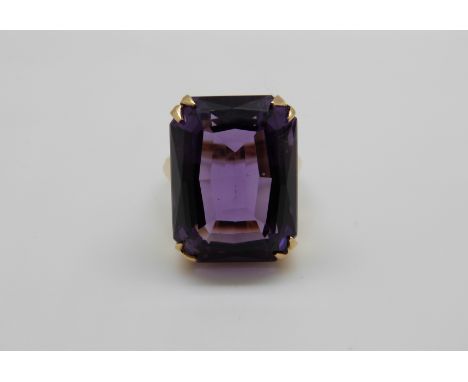 An 18ct gold ring set with a large emerald cut amethyst, 13.4g, size N/O