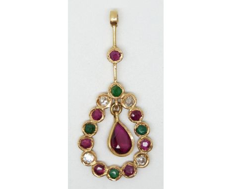 A yellow metal pendant set with a pear cut ruby surmounted by emeralds, diamonds and rubies.