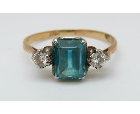 An 18ct gold ring set with an emerald cut blue topaz and two diamonds (size K) 