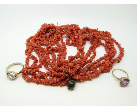 A 9ct gold ring set with an amethyst, a white metal ring and a coral necklace 
