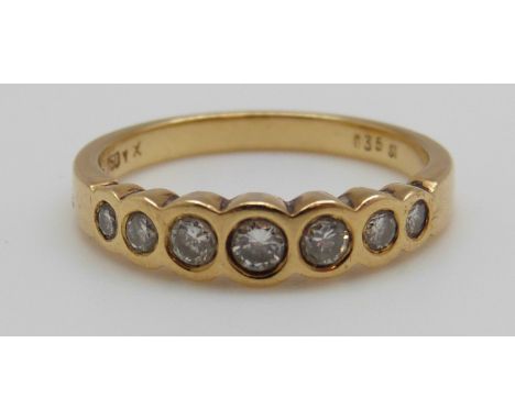 An 18ct gold ring set with seven round brilliant cut diamonds totalling approximately 0.35ct (size O)