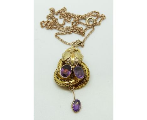 A Victorian pendant set with two oval amethysts with textured foliate design and another drop amethyst 