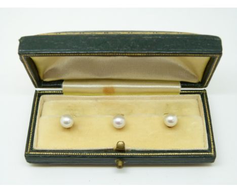 Three 9ct gold studs each set with a pearl  in original box 