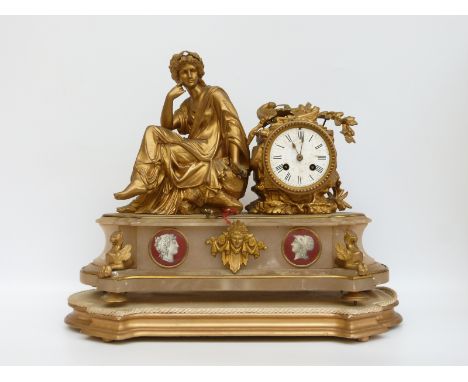 A 19thC ormolu and marble mantel clock with seated Romanesque female figure to one side, and lyre, sickle and oak leaf orname