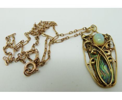 An Art Nouveau yellow metal necklace set with a piece of abalone to the ground and an opal cabochon in the style of Archibald