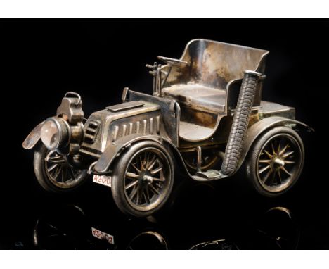 An Edward VII novelty hallmarked silver table lighter formed as a veteran car, possibly a De Dion Bouton, with sliding seat t