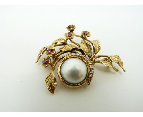 A Givenchy 14k gold brooch set with a central mabe pearl with a crescent of diamonds, surrounded by foliate and floral decora