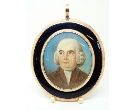 A large Victorian gilt mourning pendant, the central portrait on ivory of a gentleman set within a border of blue enamel, ver