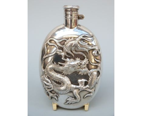 A Chinese white metal hip flask decorated with a dragon and having a bayonet cap, marked inside cap with Chinese silver marks