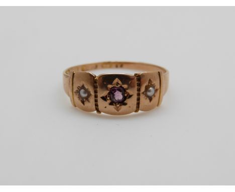 A Victorian 15ct gold ring set with an amethyst and seed pearls, 1.9g, size L 