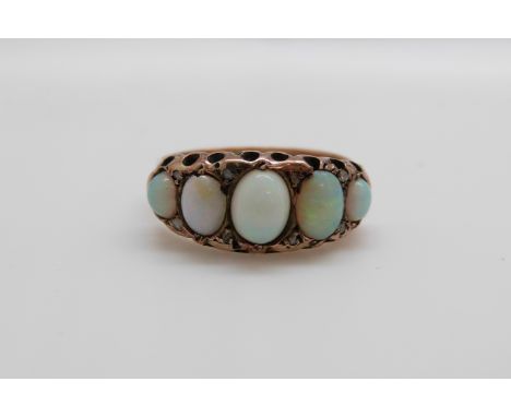 A 9ct gold ring set with five graduated opal cabochons and diamonds, Birmingham 1916 (size O/P)