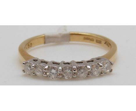 An 18ct gold ring set with seven diamonds totalling approxiamtely 0.25ct, 3.7g (size P)