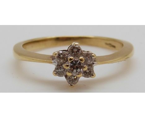 An 18ct gold ring set with diamonds in a cluster, 2.6g (size K)